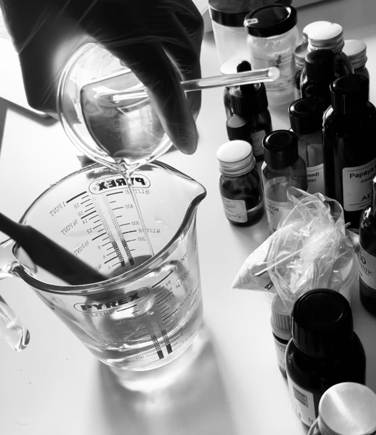 mixing carrier oil ingredients into a pyrex just