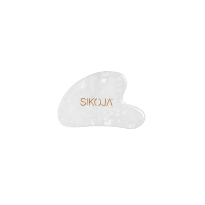 clear quartz gua sha against white background