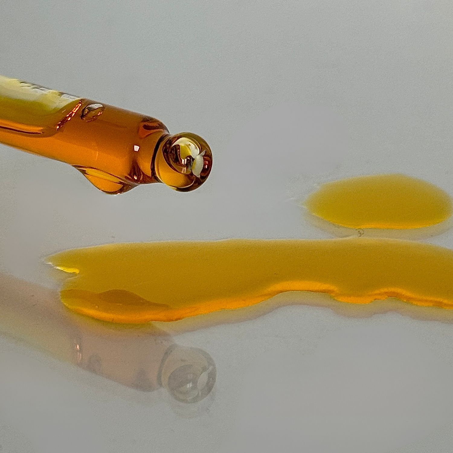zoomed in pipette shot and oil on the table