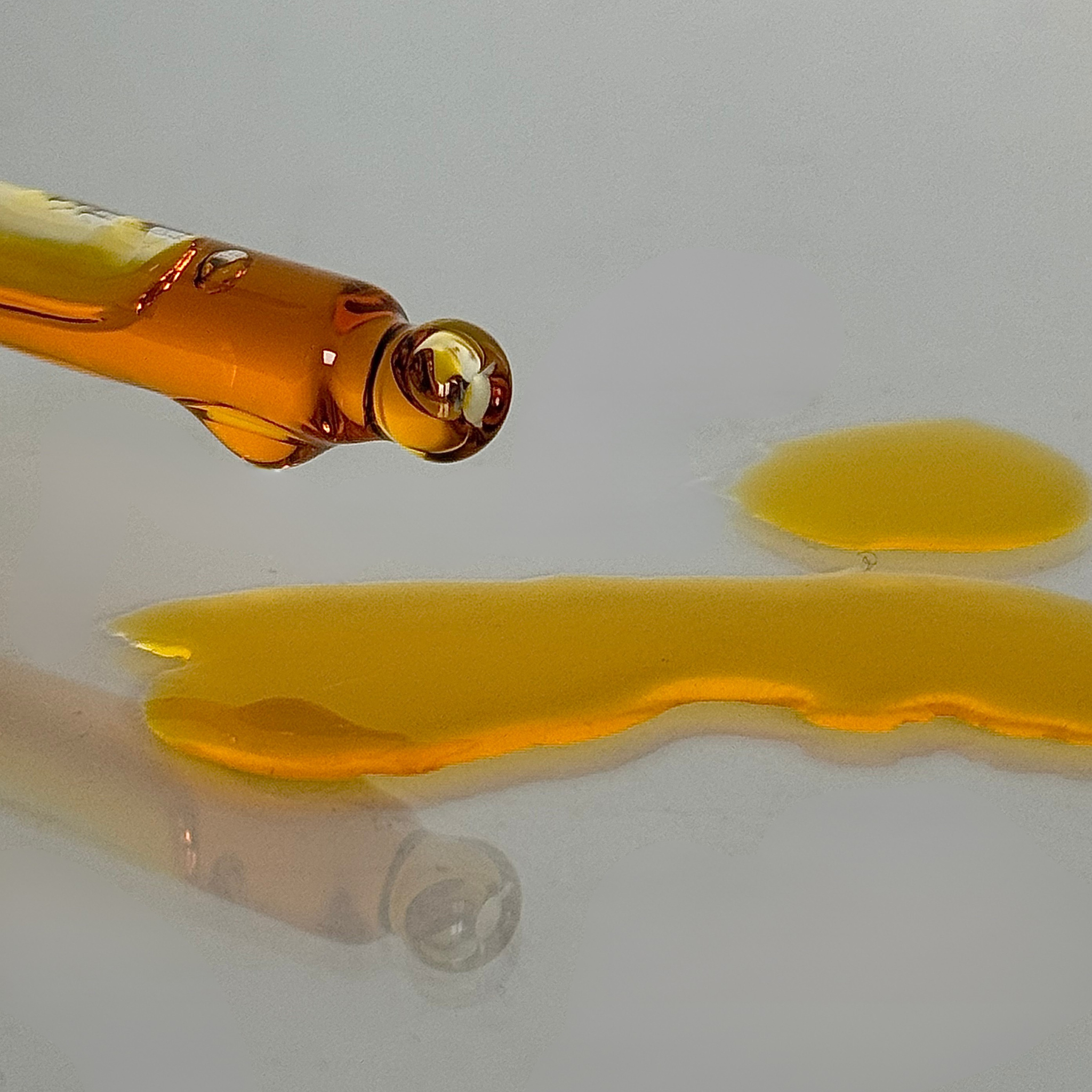 zoomed in pipette shot and oil on the table